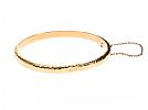 GOLD-TONE HAMMERED BANGLE at Ross's Online Art Auctions